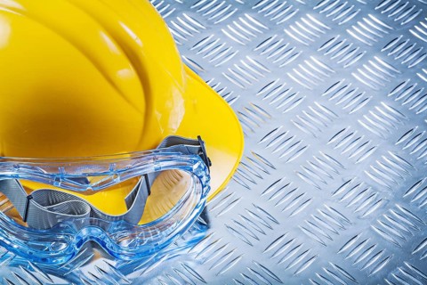 Safety spectacles building helmet on corrugated metal plate top view construction concept