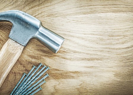 Claw hammer stainless nails on wooden board building concept