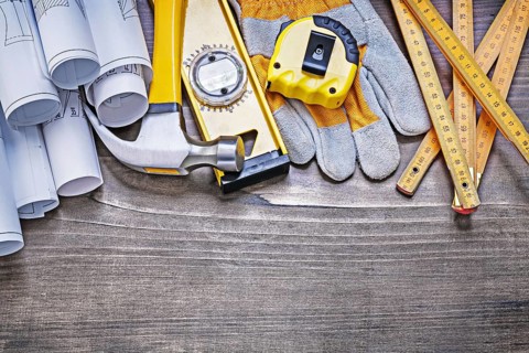 Pine wooden vintage board with construction plans and set of building objects maintenance concept