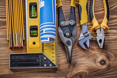 Variation of construction tools on vintage wooden board