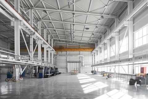 Yellow overhead traveling gantry crane beam on the pillars and truss ceilings of industrial