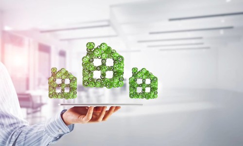 Close of businessman holding tablet pc with house sign made of connected gears. Mixed media