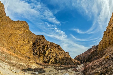 Picturesque and multi-color Black canyon in ancient Eilat mountains. Israeli warm winter. Photo