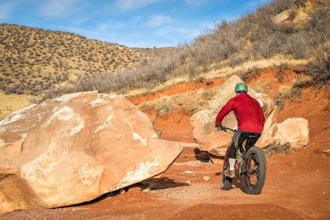 Riding a fat bike on mountain desert trail in Red Mountain Open Space in northern Colorado, late