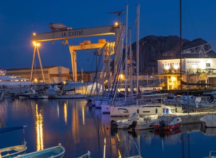 The famous harbour of La Ciotat, France, with fishing and sailing boats, in front of the industrial