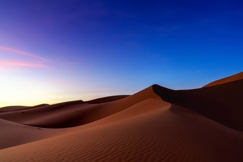 A view of the sand dunes at Erg Chebbi in Morocco at sunset