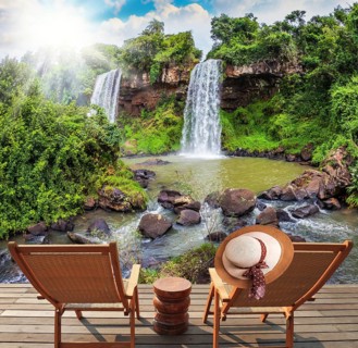 Two waterfalls from Iguazu Falls fall into a small quiet pond. The concept of ecological tourism.