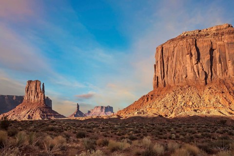 The famous cliffs Mittens in Monument Valley. The rocks - outcrops made of red sandstone. Bright