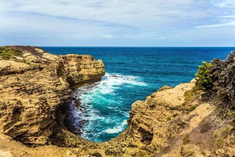 The Great Ocean Road of Australia. Picturesque ocean bay with clear green water. The coastal cliffs