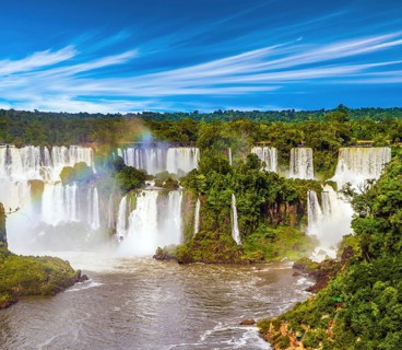 Several waterfalls from Iguazu Falls. Powerful two-stage waterfall creates rainbow and watery dust.