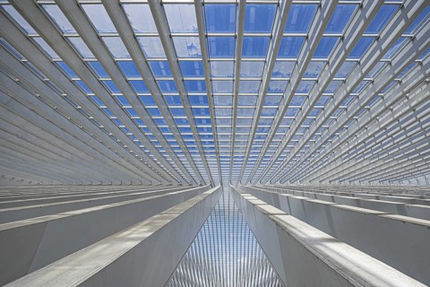 Symmetrical detail of a modern glass roof in an urban environment, railway station, Liège, Wallonia