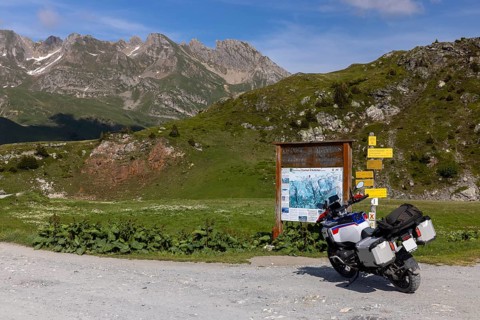 Signpost and information board, BMW R1300 GS Adventure motorbike on gravel road, Cormet d'Areches