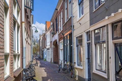 Street with historical houses in Delft downtown, Netherlands