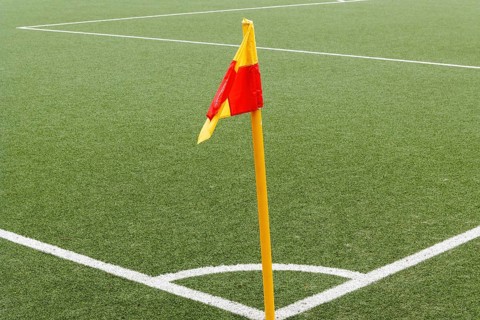 Corner of a ball soccer field wwith pile and flag
