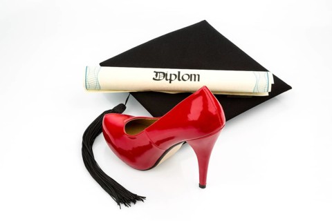 A red woman's shoe on a doctor's hat, symbolic photo for equal rights and woman's power Austria