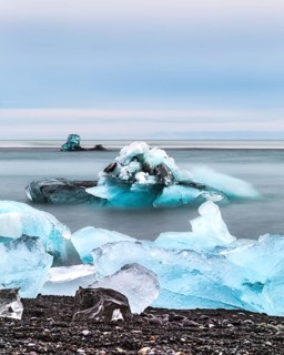 Blue icebergs and chunks floating in a calm ocean scene, iceberg Iceland, glacier, snow, ice rock,