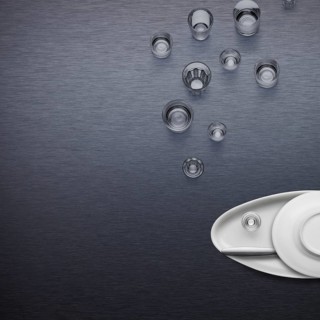 Creative dishware concept, figure of a fish blowing bubbles made of plates and glasses