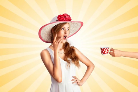 Creative vintage photo of a shocked pin up girl being treated with polka dot cup of hot tea or