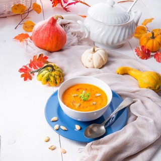 Healthy pumpkin soup with ginger carrots and coconut milk