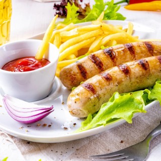 Grilled bratwurst with chips and cold beer