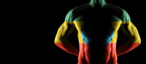 Ethiopia flag on muscled male torso with abs, black background
