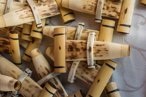 Dozens of handmade bamboo flutes in the view