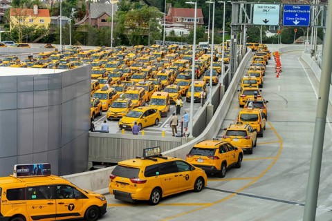 Yellow taxi cabs wait in line at LaGuardia Airport before picking up their fares