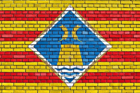 Flag of Formentera painted on brick wall