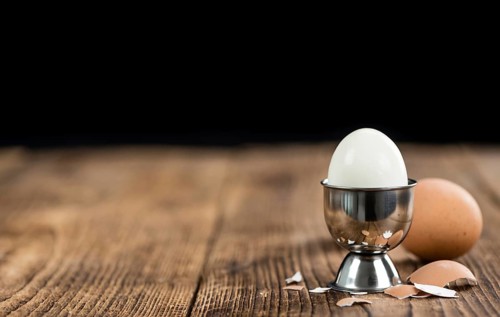 Wooden table with boiled Eggs (selective focus, close-up shot)