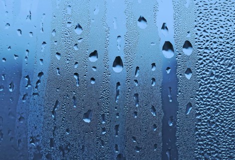Natural large and fine water drops on glass