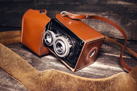 Vintage photo camera on a wooden surface