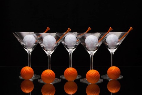 Five glasses of champagne with golf balls