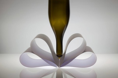 Symmetry abstract Paper Background with wine glass on a glass table