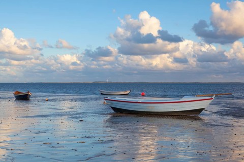 Fishing boats on the empty beach, Hjerting, Jutland, Denmark. Hjerting is a district of Esbjerg in