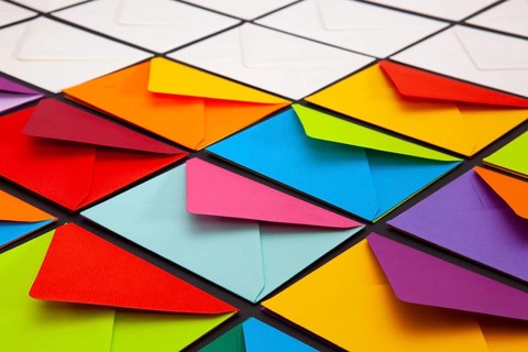 Composition with white and colored envelopes on the table. The photo suitable for various holidays