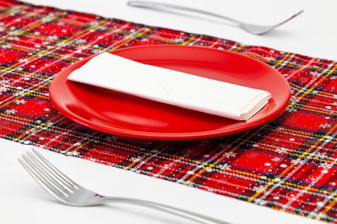 Red plate and Christmas decoration on the white wooden table.Top view. Flat Lay Image