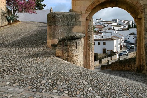 Narrow alleyway with cobblestones makes 180-degree turn in mountain village