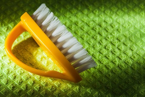 New yellow plastic brush on washcloth