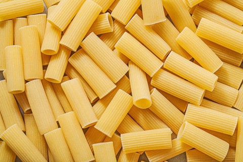 Short-cut raw pasta background food and drink concept