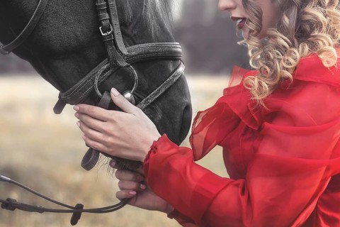 Love for animals. young Woman with no face dressed in an elegant vintage dress, gently cuddling a