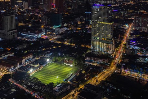 A picture of the EV Arena Kelab Sultan Sulaiman football field, and the Tamu Hotel and Suites Kuala