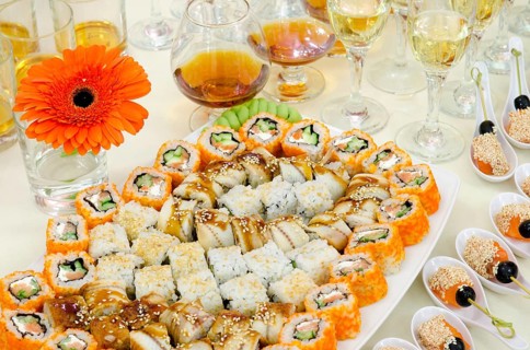 A lot of sushi and drinks on buffet table, catering