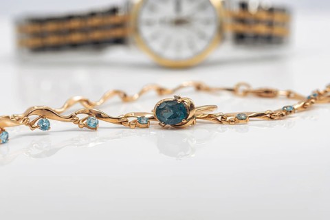 Accessories and jewelry for a fashionable girl : gold ring, necklace and original wristwatch