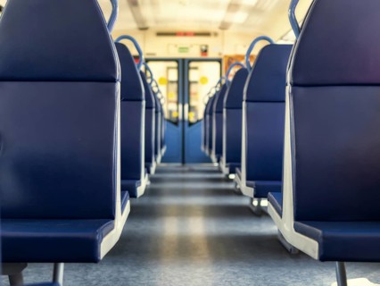 An empty train car with new blue leather seats