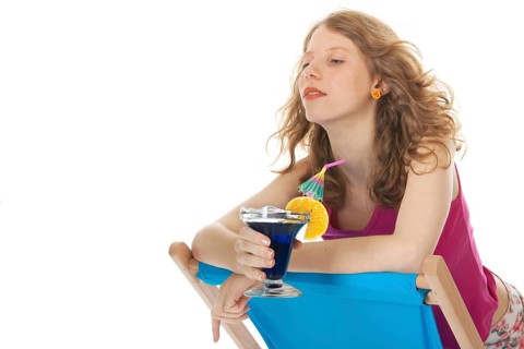 Younb blond woman with luxury cocktail at the beach