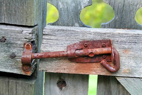 Rusty old latch on an old wooden garden gate