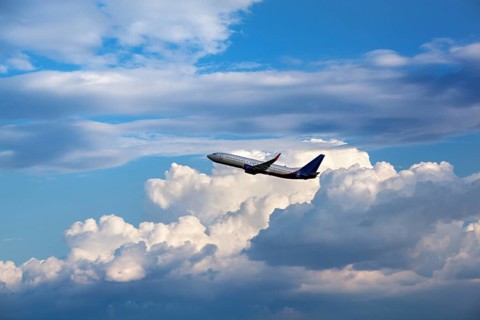 Modern passenger airliner flying in the cloudy sky