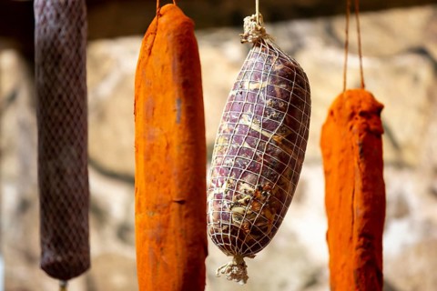 Dried green, brown and orange beef and pork jerky is shown at a food and drink exhibition