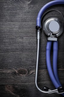 Medical stethoscope on wooden background top view medicine concept