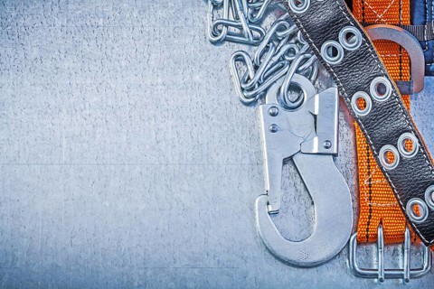 Safety belt metal chain carabiner hook on metallic background copy space
